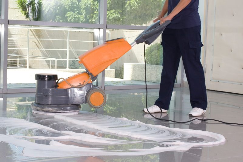 Person using floor cleaning machine